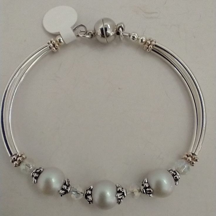 Very Unique Bracelet Made With Swarovski Faux Pearls In A Soft Dove Grey A Long With Czech Crystal With The Aurora Borealis Finish And Accented In Silver-Plated Components. Super Easy Magnetic Clasp (But Do Not Use If You Have A Pacemaker, Let Me Know And I Can Change The Clasp) Twin Tubular Beads Form The Sides Of The Bracelet And Hug Your Wrist. There Is Also A Light Blue Version In Another Listing And Hopefully More Colors Coming. All Jewelry Branded Swarovski Or Arsinoe Are Handmade By Me And With The Cost Of Materials, Packaging And Poshmark's Fee I Don't Have Much Wiggle Room On The Price. Any Clothing Or Unbranded Jewelry I Do Have Wiggle Room. Thank You For Understandi Elegant Adjustable Crystal Bracelet With Silver Beads, Adjustable Nickel-free Silver Crystal Bracelet, Classic Silver Crystal Bracelet For Anniversary, Silver Crystal Bracelet For Anniversary, Elegant Silver Pearl Bracelet With Extender, Adjustable Jewelry With Silver Accents For Gifts, Adjustable Silver Crystal Bracelet Hypoallergenic, Classic Silver Beaded Bracelets For Anniversary, Adjustable Silver Hypoallergenic Crystal Bracelet