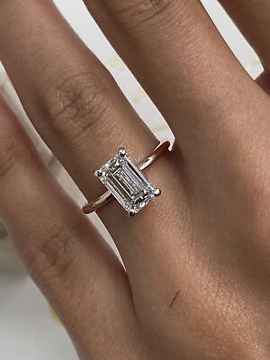 a woman's hand with an engagement ring on it and a diamond in the middle