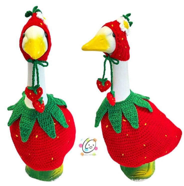 two crocheted stuffed birds wearing strawberries