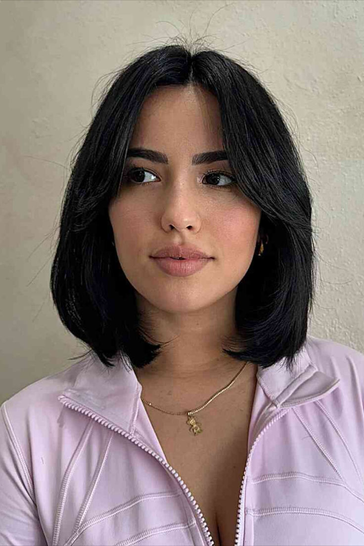 Sophisticated woman with a longer bob and middle-parted bangs Lived In Bob Haircuts, Haircuts In Style, Lob Haircut Black Hair, Short Hair Above Shoulder Straight, Black Bob With Curtain Bangs, Straight Long Bob Hairstyles, Trendy Bob Hairstyles Thick Hair, Short Hairstyle Middle Part, Middle Part Bob With Layers