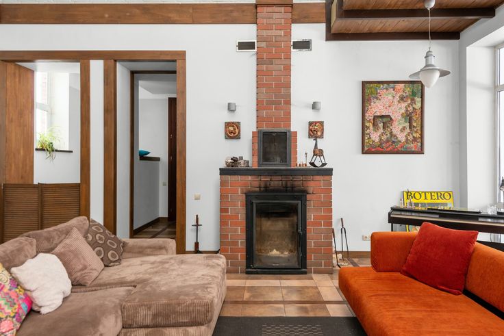 a living room filled with furniture and a fire place