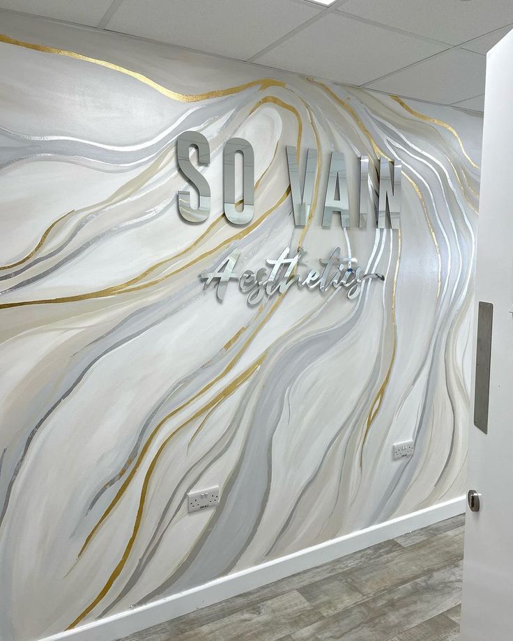 an office wall with the words sovanin written on it in silver and gold