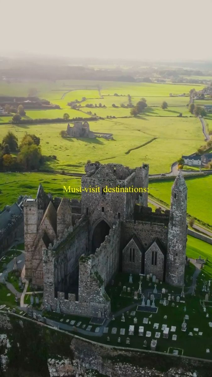 an aerial view of the ruins and graveyards of dunluy castle in county down ireland