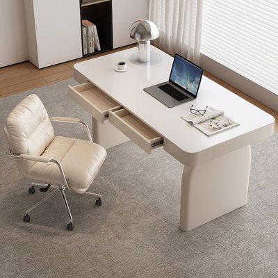 a white desk with a laptop on it and a chair next to it in front of a window