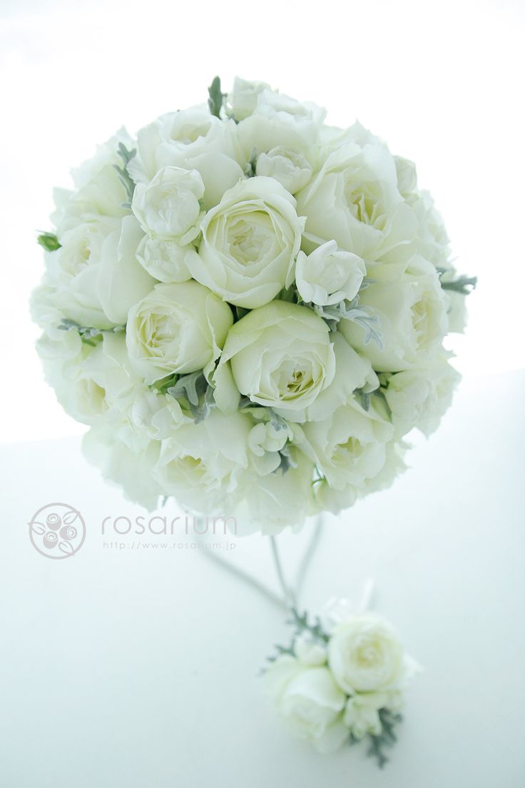 a bouquet of white flowers sitting on top of a table