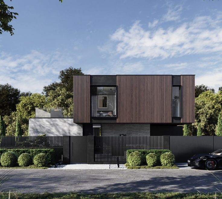 a black car is parked in front of a house with wooden sidings on it