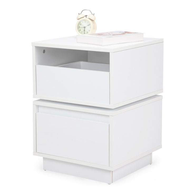 a white nightstand with two drawers and an alarm clock on the top one drawer is open