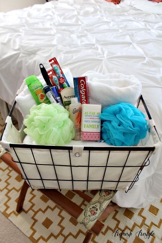 a basket filled with toiletries on top of a bed