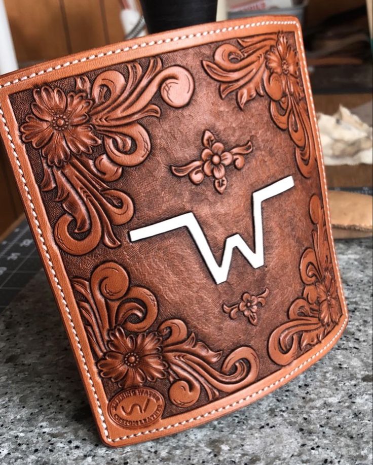 a brown leather wallet sitting on top of a counter