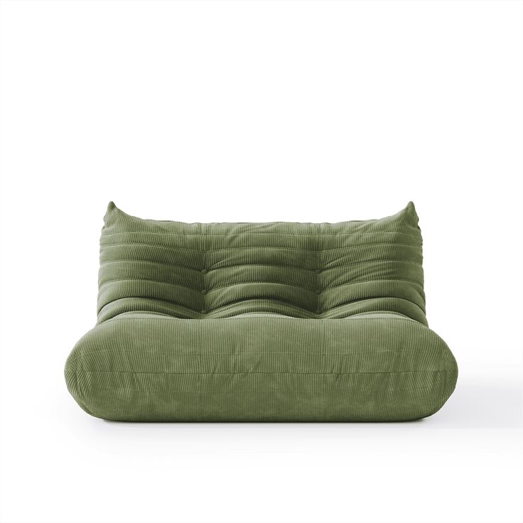 a green couch sitting on top of a white floor