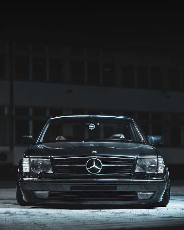 a mercedes benz is parked in the dark