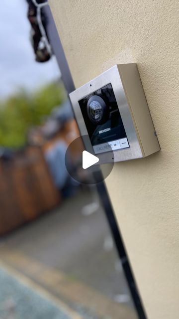 an appliance mounted on the side of a building with a camera attached to it