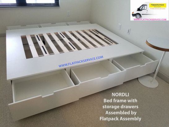 a bed frame with storage drawers assembled by flatpack assembly