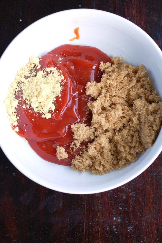 a white bowl filled with food on top of a wooden table