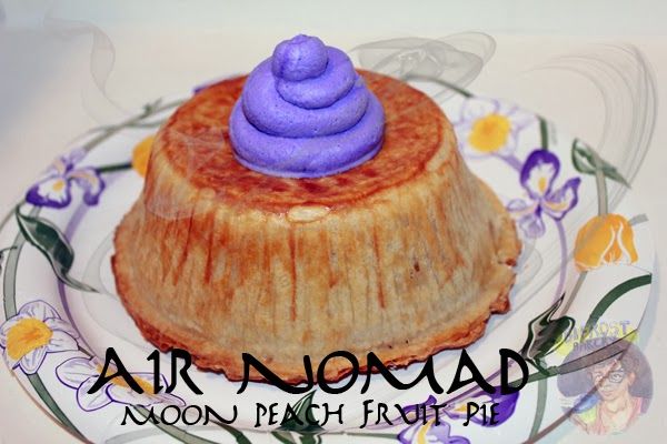 there is a small pastry on a plate with purple icing in the shape of a flower