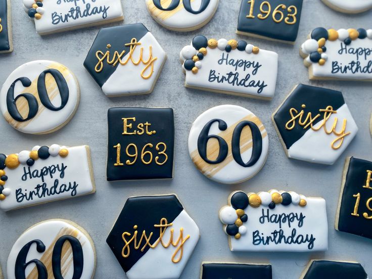 decorated cookies with black and white icing are arranged in the shape of sixty years