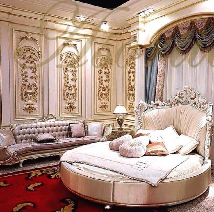 a fancy bedroom with white furniture and red carpet