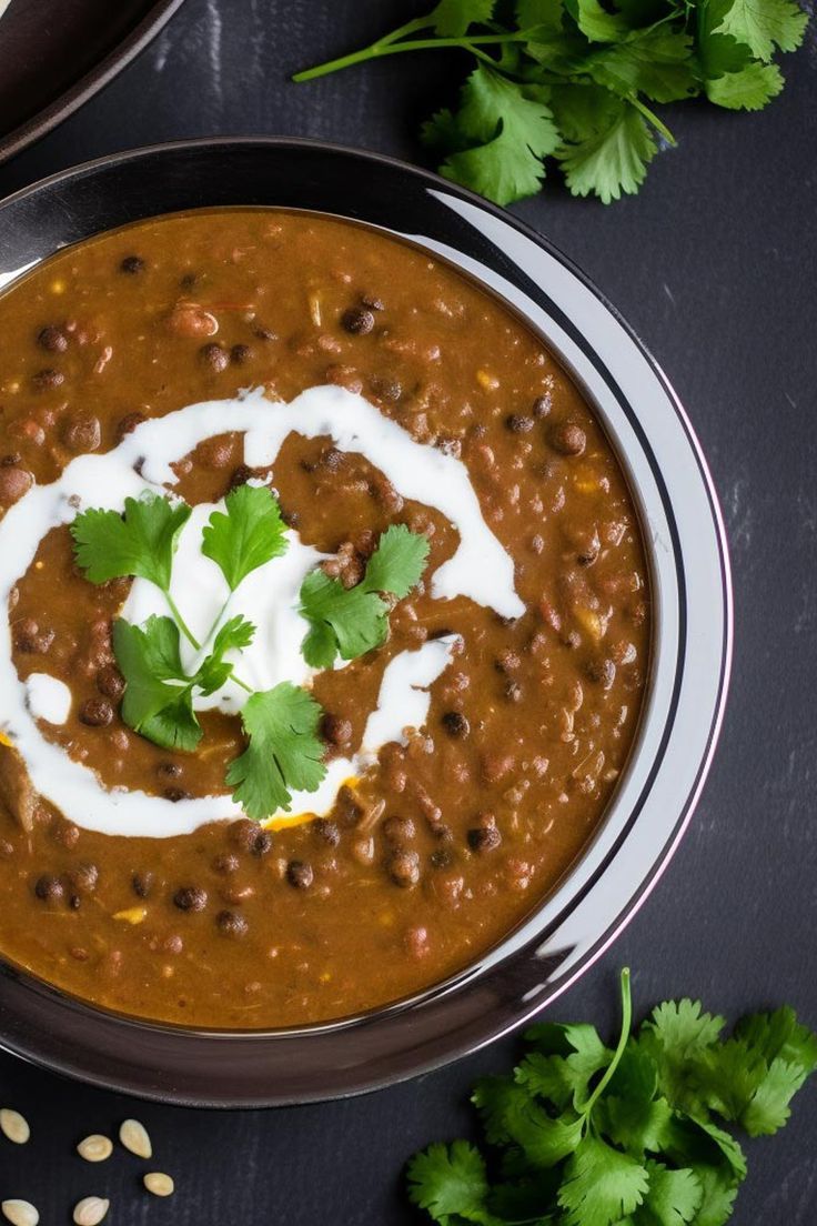 a bowl filled with beans, sour cream and cilantro