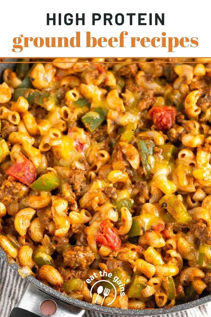 a skillet filled with ground beef macaroni and cheese on top of a table