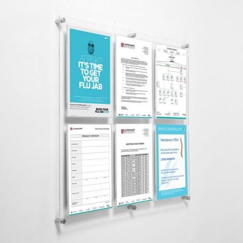 a bulletin board mounted to the side of a wall with several papers attached to it