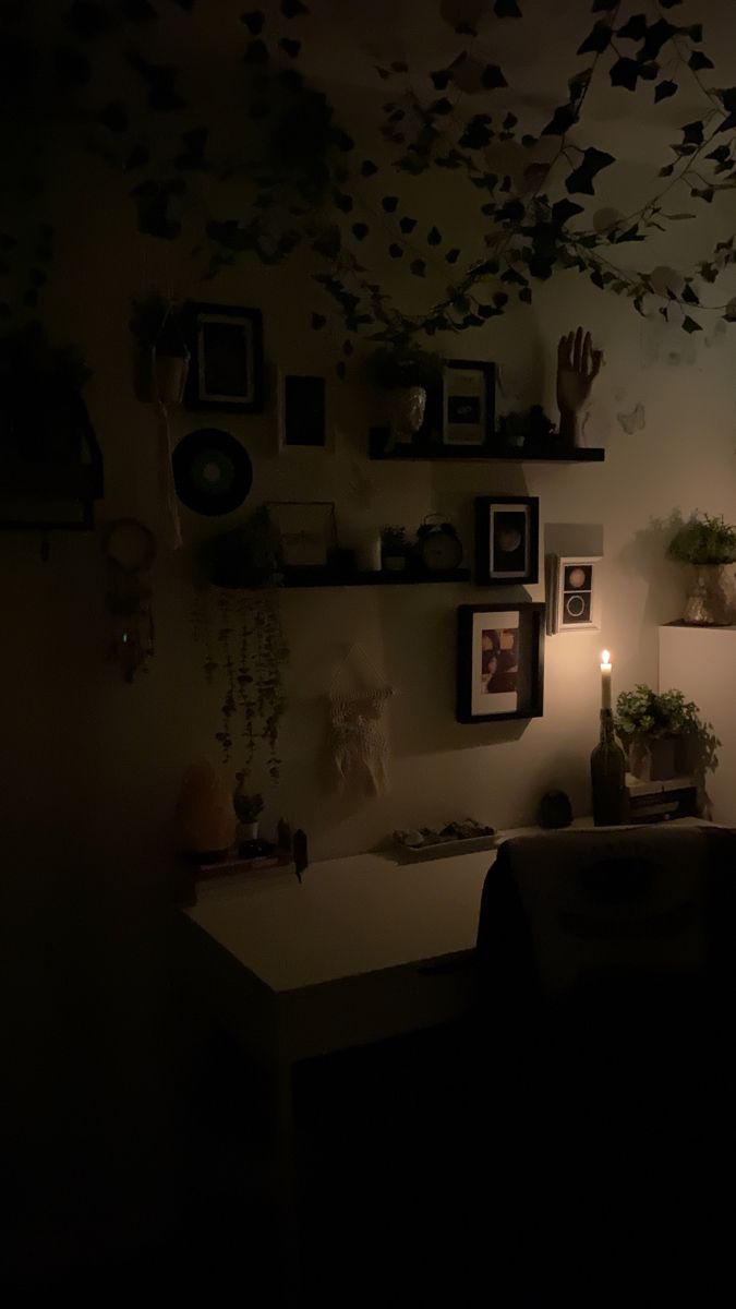 a living room filled with furniture and pictures on the wall next to a window at night