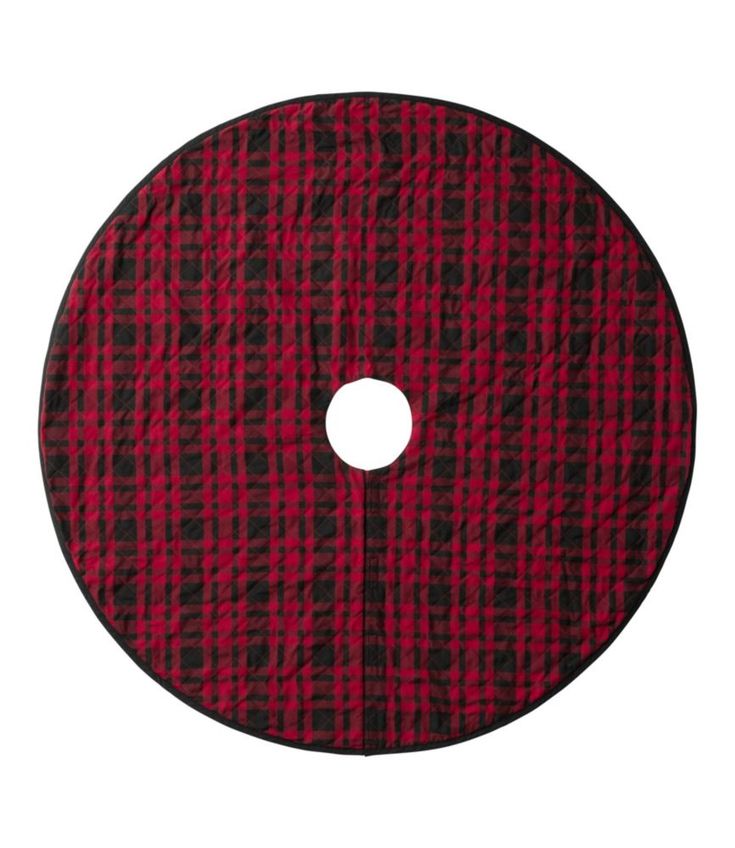 a red and black plaid pattern on a white background with a circular hole in the center