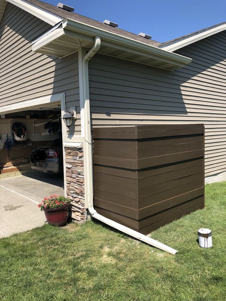 a house with a garage attached to it's side and grass in the front yard