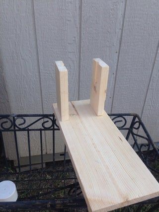 two pieces of wood sitting on top of a bench