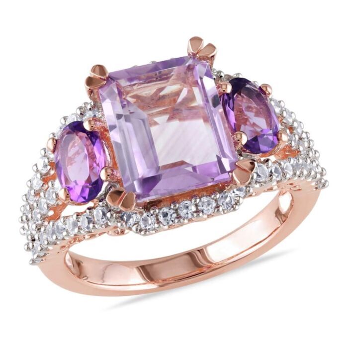 This stunning 3-stone multi-color engagement ring is crafted in rose gold plated sterling silver and features a single emerald-cut dazzling rose de france (3.13 ct. T.W.) at the center and secured with two oval-cut amethyst-africa (0.9 ct. T.W.). Further, the ring is enhanced with 62 round-cut sparkling (0.62 ct. T.W.) white sapphires set on its band. Rose Gold Plated Ring, White Sapphire Ring, 3 Stone Rings, Men Ring, Zircon Ring, Sapphire Stone, Gold Plated Rings, White Sapphire, Amethyst Ring