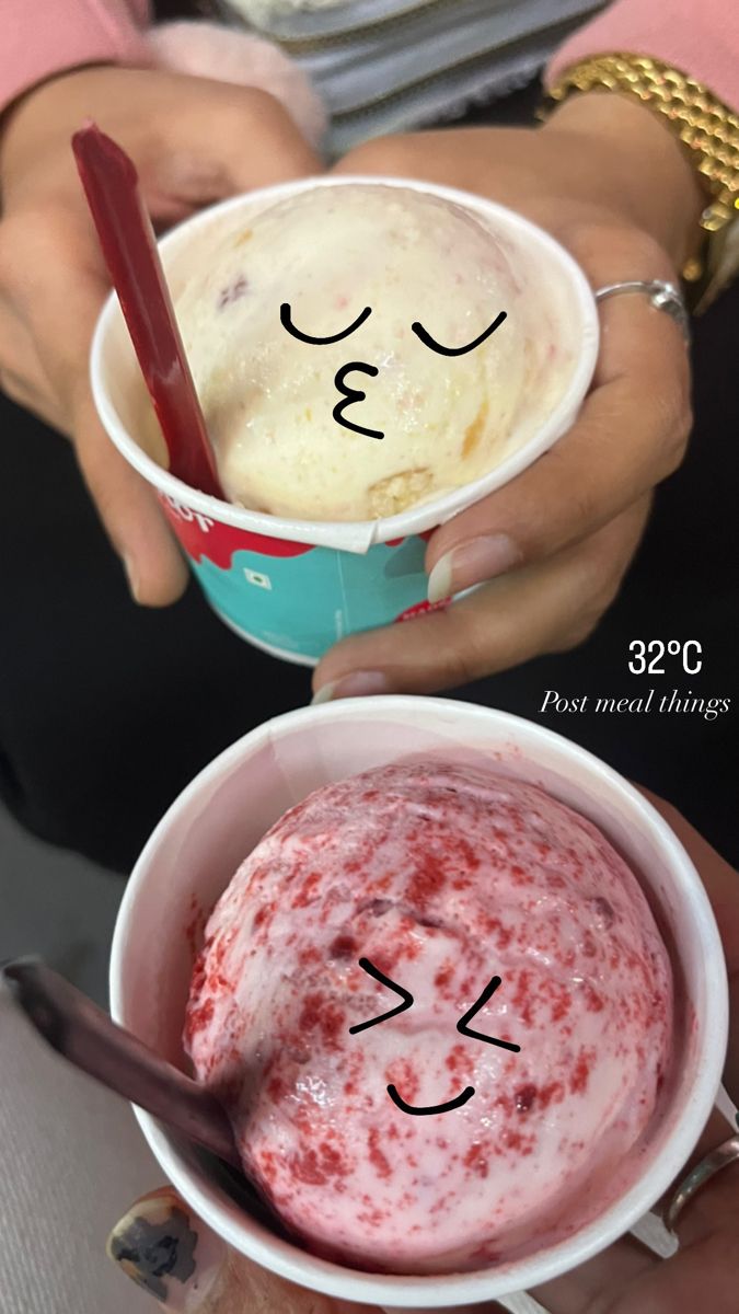 two people holding ice cream in their hands with faces drawn on the top and bottom