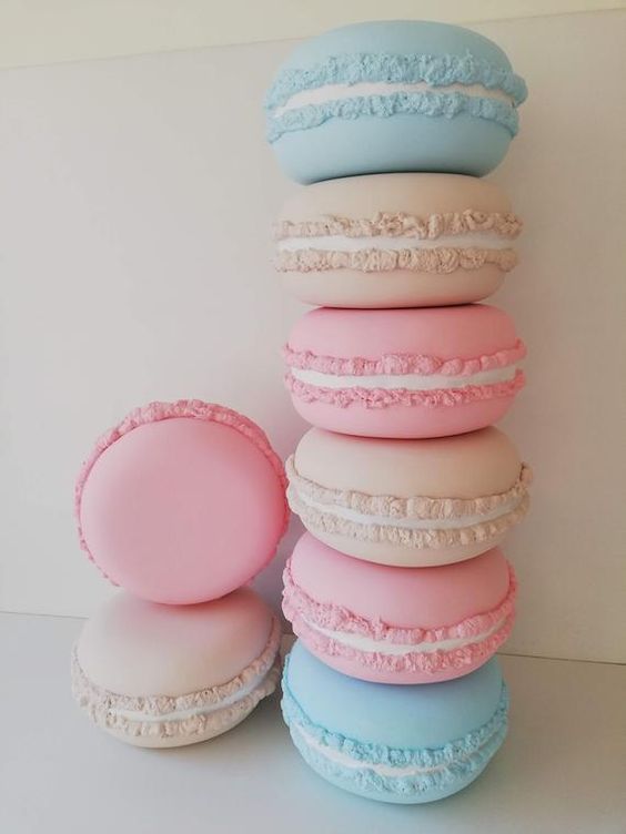 macaroons stacked on top of each other in pastel blue, pink and white