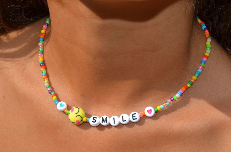 "This dainty necklace is a fun combination of varied, colorful seed beads combined with darling little, emoji smiling faces and the letters spelling smile with hearts.  It is super cute and darling. Lightweight and perfect for a little girl's gift! Clasp is a sterling magnetic clasp (for convenient wear and removal) and findings are all sterling silver. Necklace measures approximately just over 14\" Browse more fun items from my shop here: https://www.etsy.com/shop/uniquebeadingbyme?ref=seller-p Trendy Birthday Necklace With Letter Beads, Fun Adjustable Necklace With Letter Beads, Fun Adjustable Letter Beads Necklace, Playful Personalized Multicolor Beaded Necklaces, Trendy Colorful Beaded Necklaces With Letter Beads, Casual Beaded Necklaces With Letter Beads As A Gift, Trendy Colorful Beaded Necklace With Letter Beads, Casual Beaded Necklace With Letter Beads For Gift, Cute Letter Beads Beaded Necklace As Gift