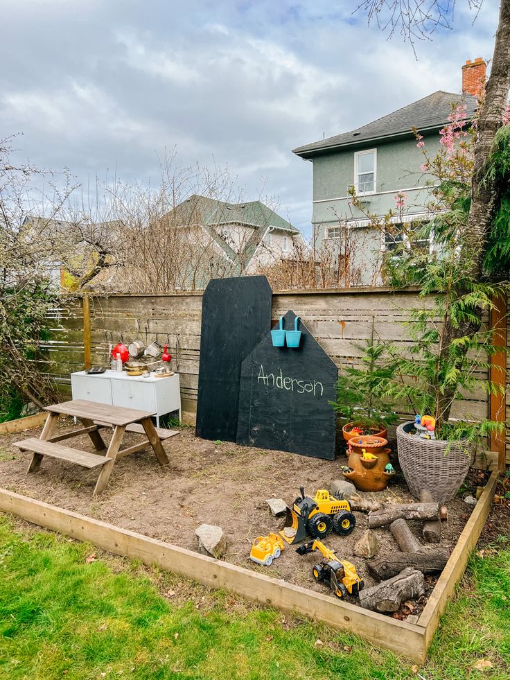 Nature play area with chalkboard, mud kitchen, construction zone and Dino habitat Toddler Garden Ideas, Mud Kitchen Diy, Nature Play Area, Sensory Gardens, Backyard Play Spaces, Mud Kitchen For Kids, Outdoor Kids Play Area, Outdoor Play Space, Play Area Backyard