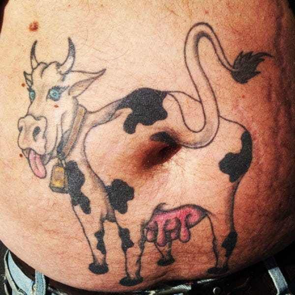 a man with a cow tattoo on his stomach