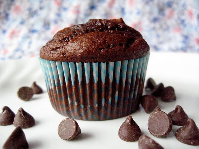 a muffin with chocolate chips scattered around it