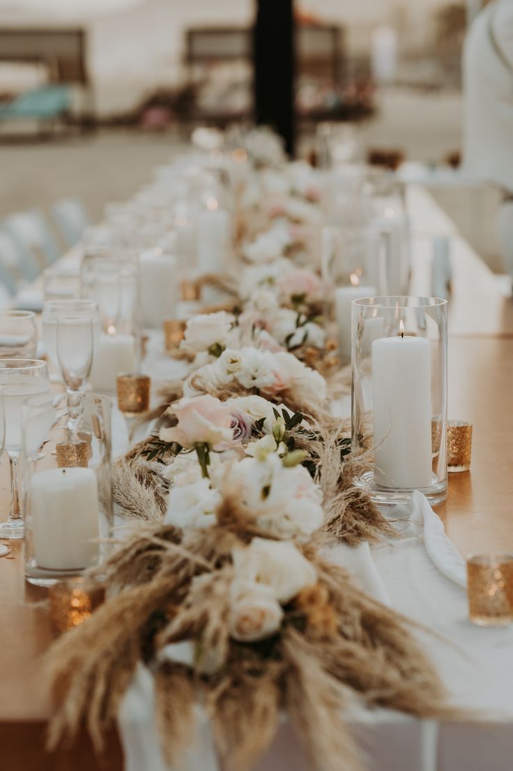 a long table with candles and flowers on it