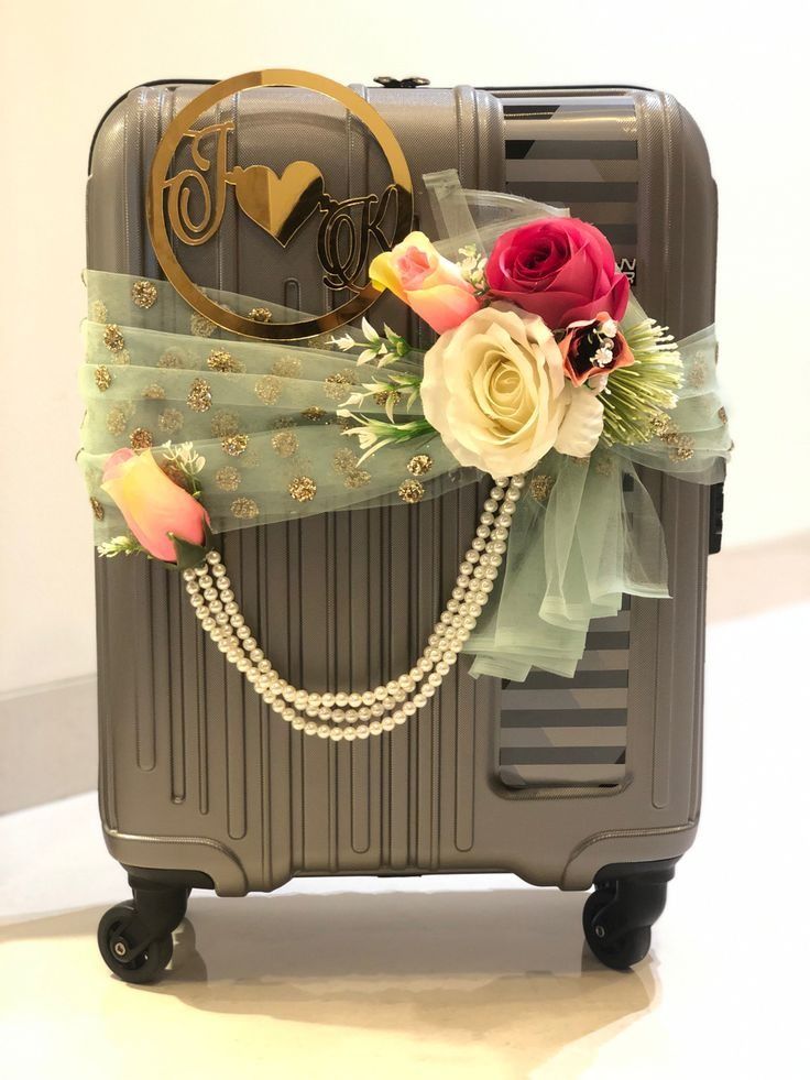 a suitcase decorated with flowers and pearls