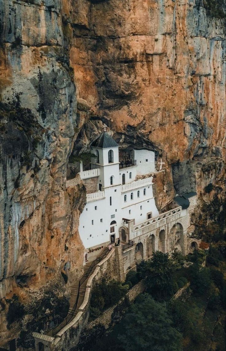 a white church built into the side of a cliff