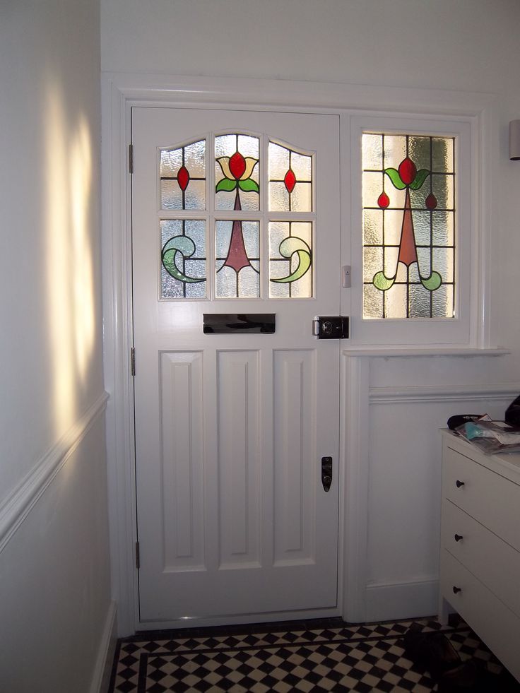 a white door with stained glass on it