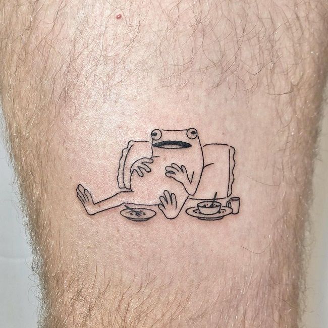 a man's leg with a tattoo on it that has a drawing of two people eating