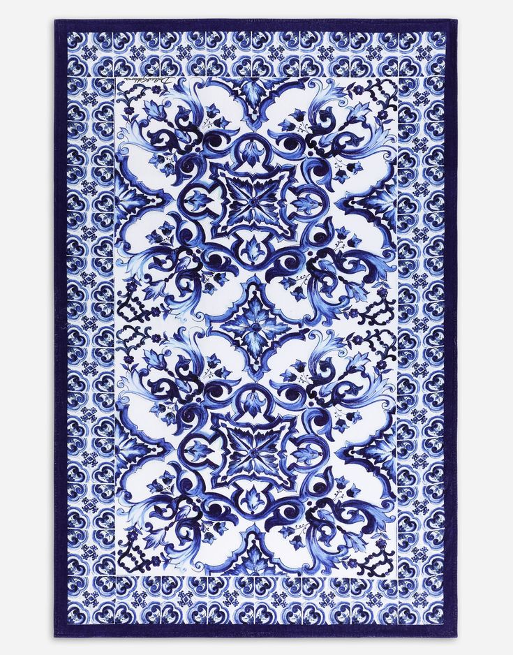 a blue and white rug with an ornate design