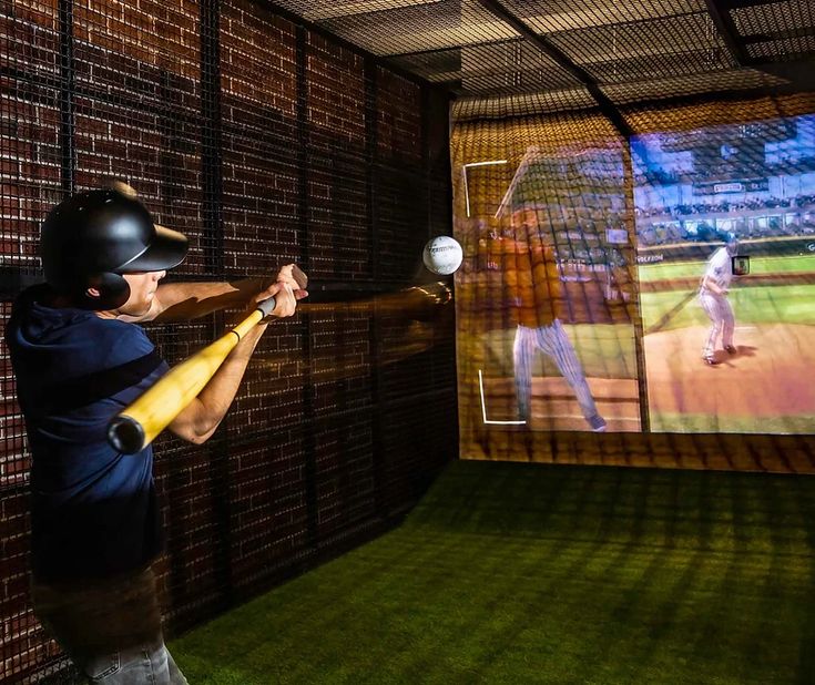 a man is swinging a bat at a baseball game on the tv screen behind him