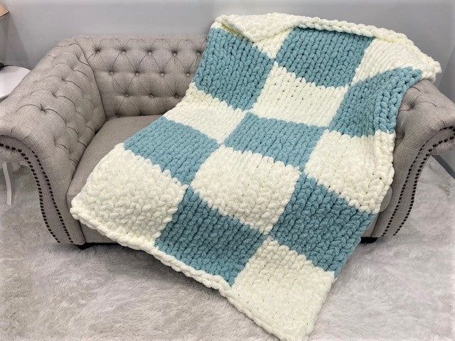 This amazingly beautiful blanket is hand knitted with BeCozi Chunky chenille yarn in Ivory and Misty green colors in Checkered pattern Size: 40x60 inches Perfect lap throw to cover your legs while sitting on a couch Perfect gift for yourself or your loved one! Make sure to watch our video on showing blanket sizes: https://youtu.be/yWoH0KmYMqw Chunky Chenille Blanket, Chunky Knit Blanket Pattern, Sitting On A Couch, Knitted Blanket Squares, Modern Crochet Blanket, Chenille Blanket, Hand Knit Blanket, Crochet Stitches For Blankets, Chenille Yarn