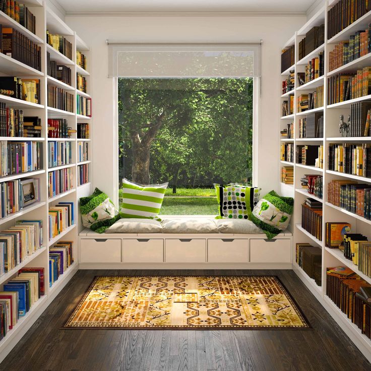 a room filled with lots of books on shelves next to a window sill covered in green and white pillows