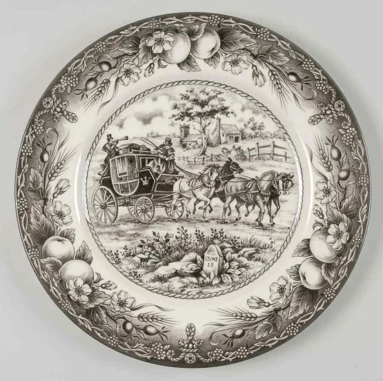 a black and white plate with an image of a horse drawn carriage in the center