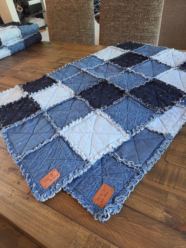 a blue and white quilt sitting on top of a wooden table