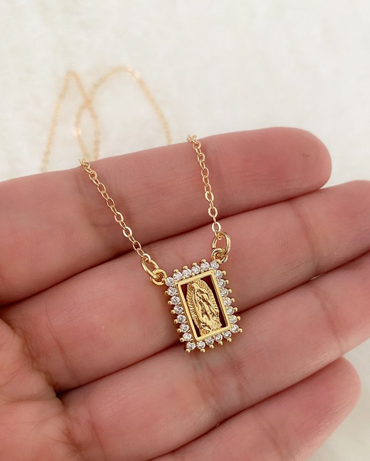 Our lady of Guadalupe necklace MATERIAL AND SIZE 18k gold plated medal 18k gold filled cable chain Cubic zirconia Size pendant: 1.4x1.2cm Length chain: you can choose it If you have questions about the product, feel free to reach me out. Don't forget to check out my other items in the store: Https://www.etsy.com/shop/nyahwithlove Spiritual Our Lady Of Guadalupe Pendant Necklace, Spiritual Our Lady Of Guadalupe Jewelry Gift, Gold Virgin Mary Medallion Jewelry, Spiritual Yellow Gold Our Lady Of Guadalupe Jewelry, Gold Our Lady Of Guadalupe Medallion Necklace, Gold Medallion Necklace With Our Lady Of Guadalupe, Gold Medallion Necklace Of Our Lady Of Guadalupe, Virgin Mary Pendant Jewelry Gift, Virgin Mary Pendant Jewelry As A Gift