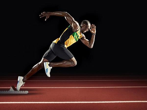 a man is running on a track in the dark