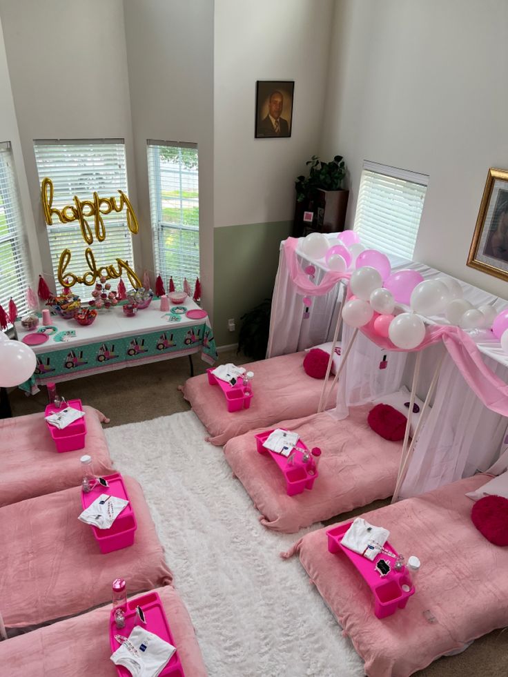 a room decorated in pink and white for a birthday party