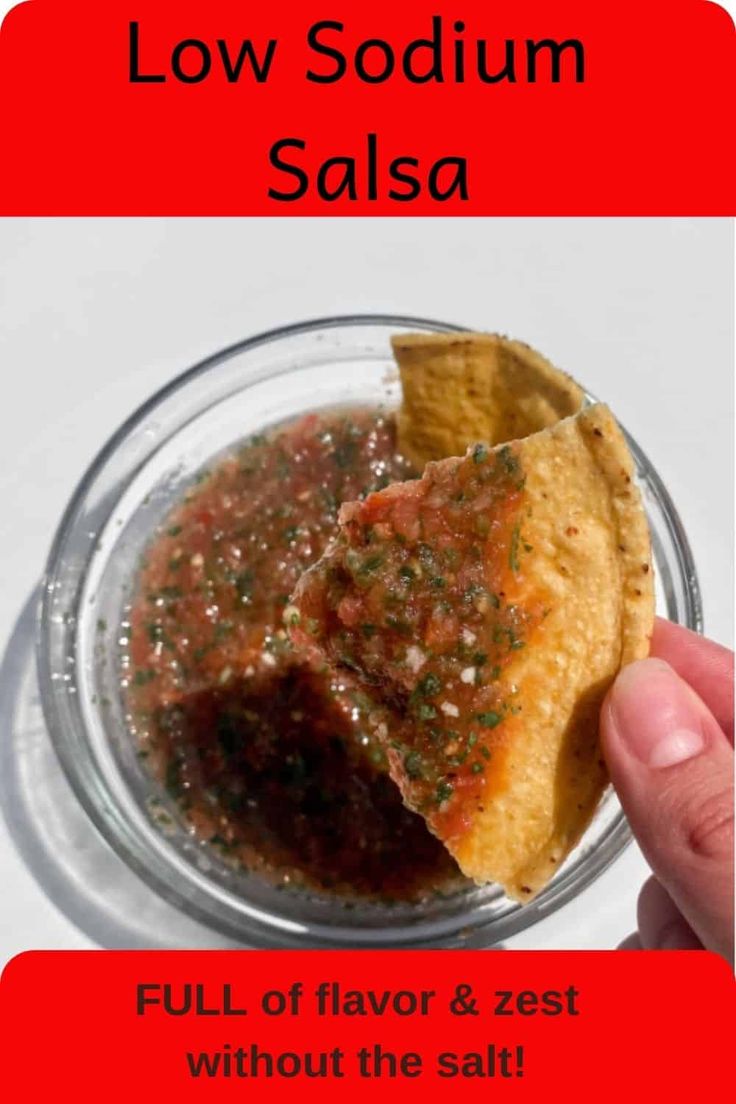 a person holding a tortilla in their hand with salsa on the other side